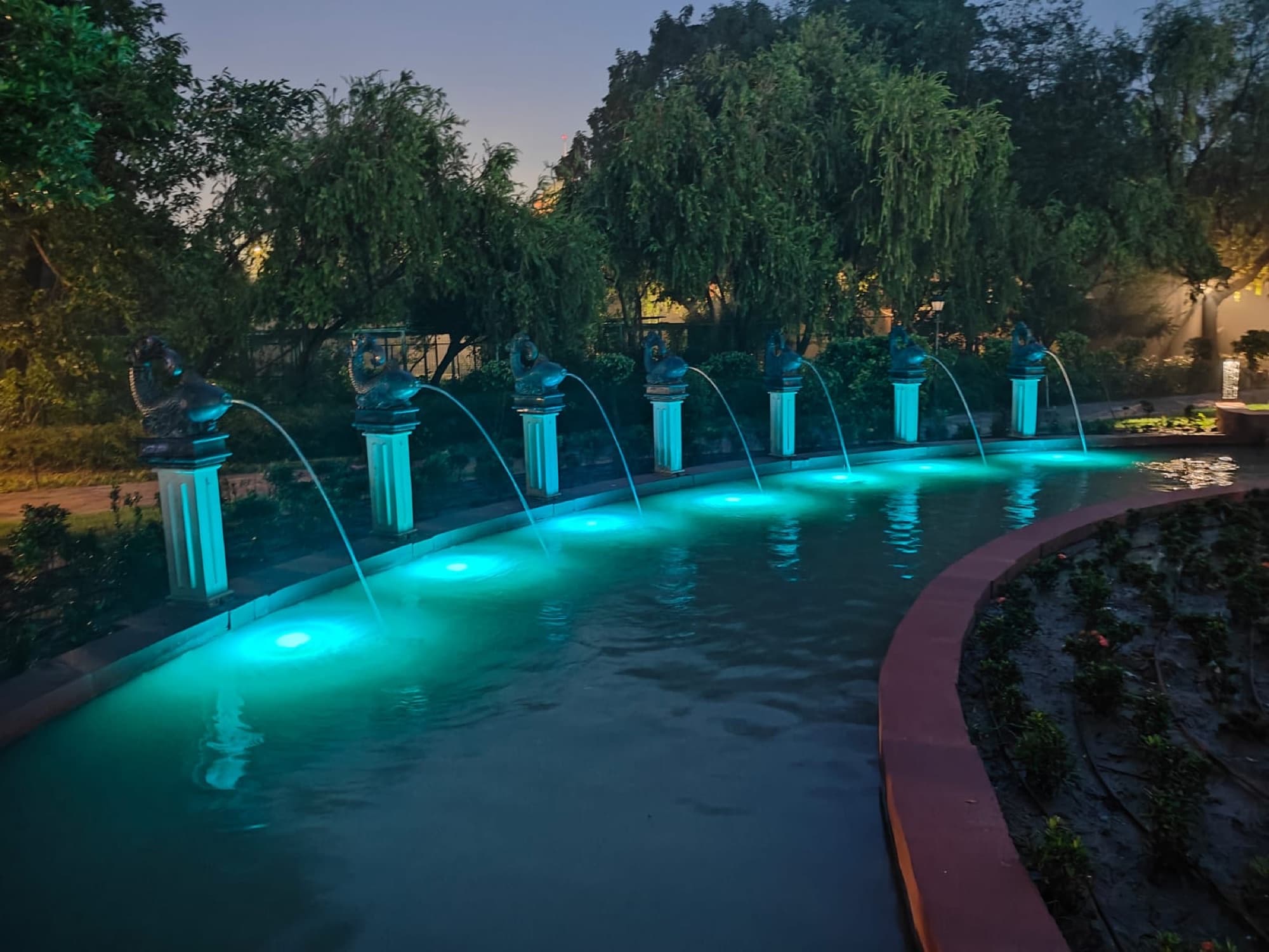 Illuminated musical fountains at dusk, President's Estate