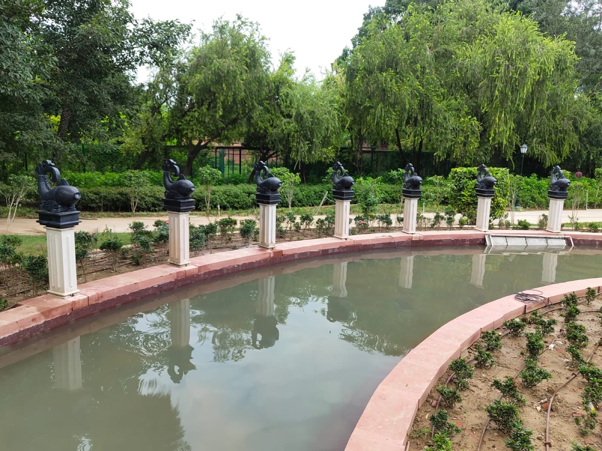 Sculpted figures lining the ornamental water channel