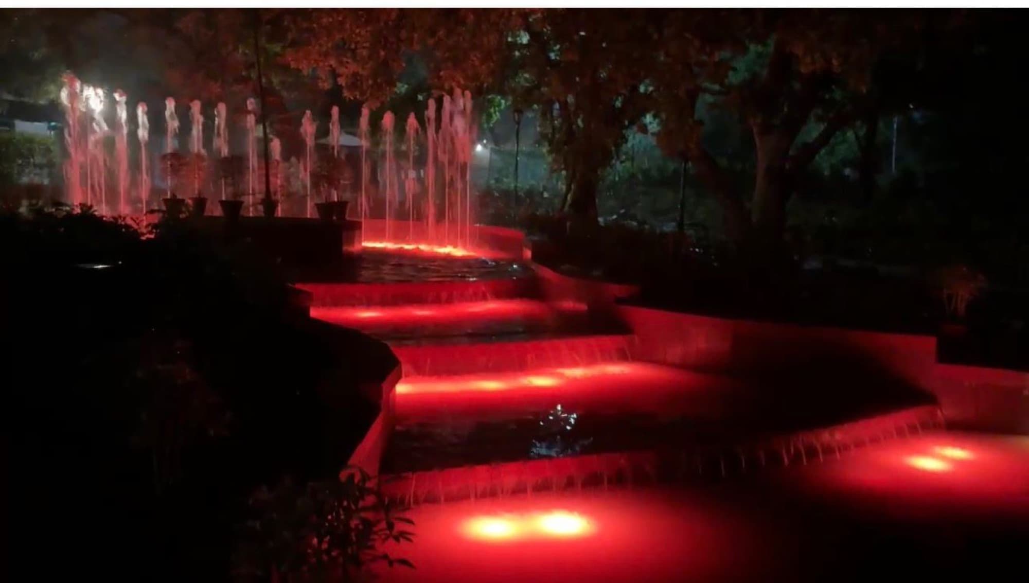 Fountains cascading over illuminated terraces