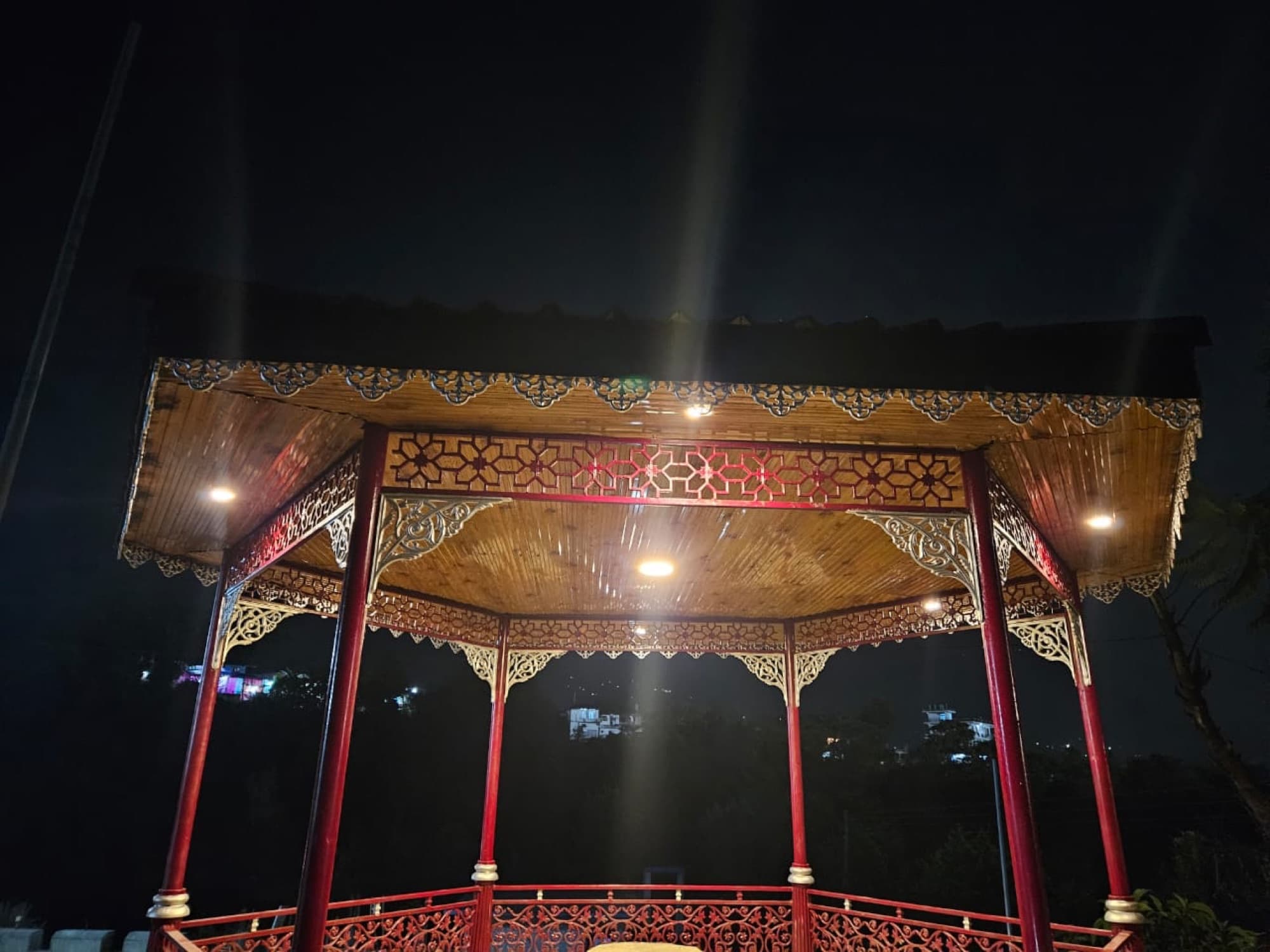 Cast-metal canopy, lit for the evening
