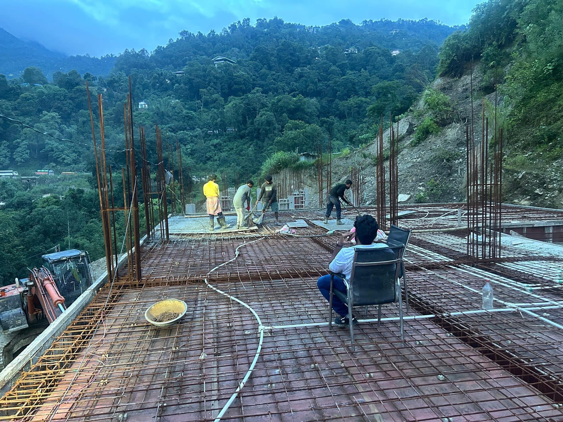 Tying reinforcement for a slab pour as dusk settles over the valley
